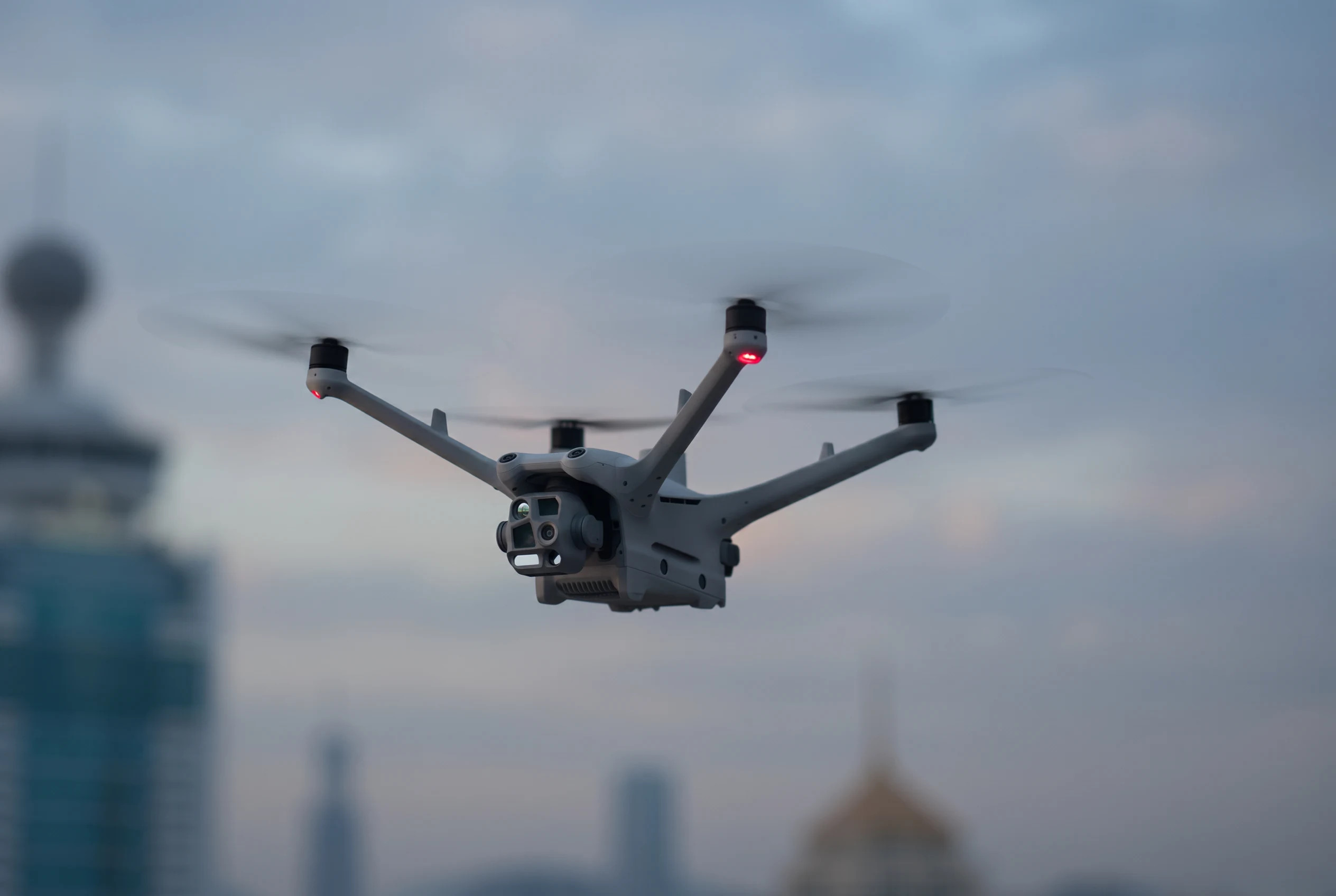 FANTM 4TD in flight above a city skyline at blue hour.